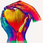 Colorful hands holding a heart